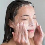 A woman washing her face in Pakistan with the best face wash